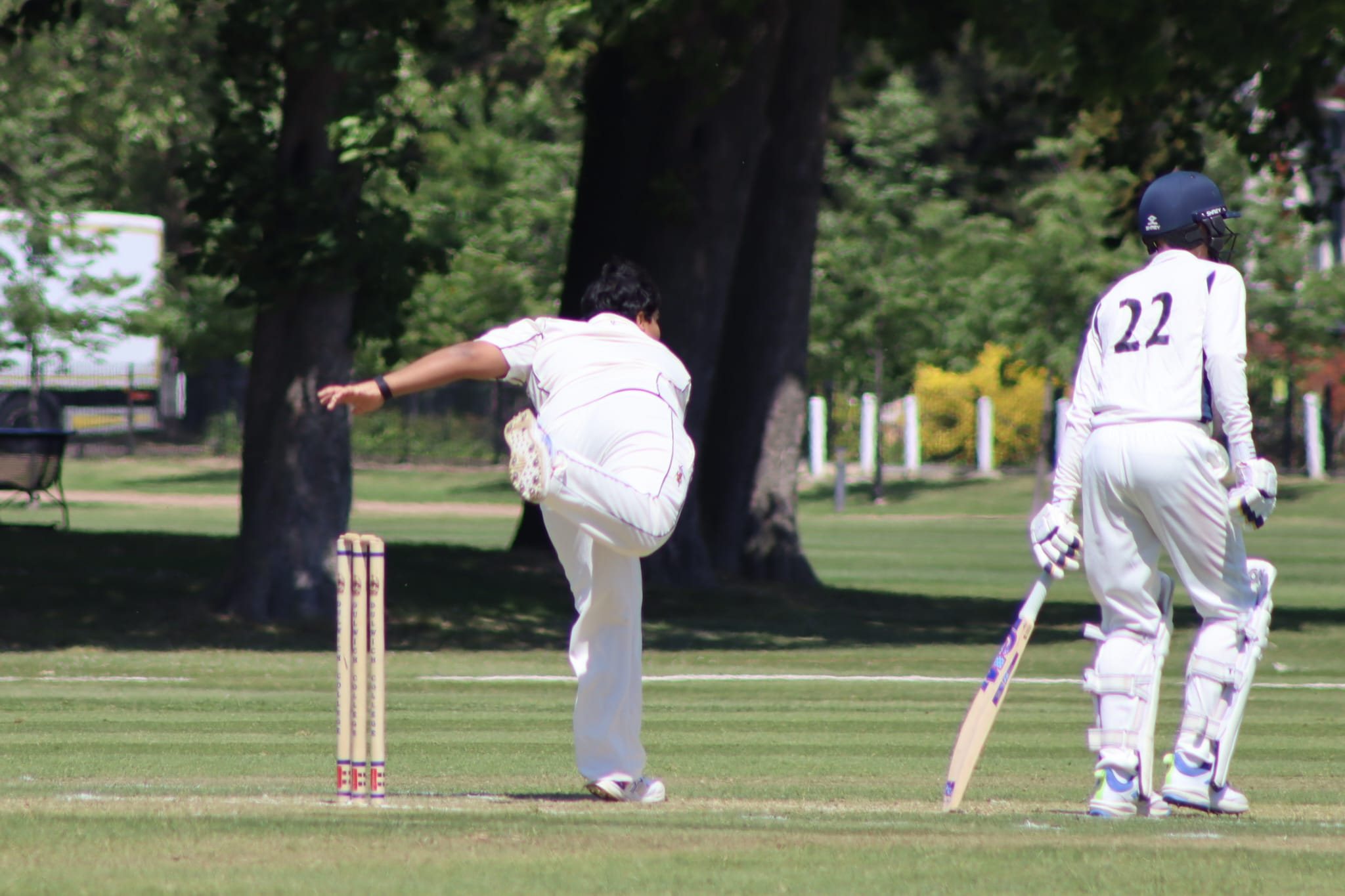 Aryan bowling in cricket whites